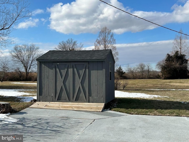 view of outdoor structure featuring a lawn