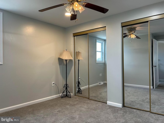 unfurnished bedroom featuring ceiling fan and carpet