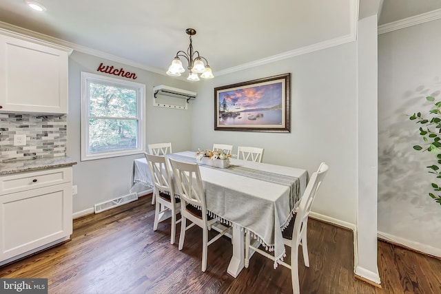 dining room with dark hardwood / wood-style flooring, a chandelier, and ornamental molding