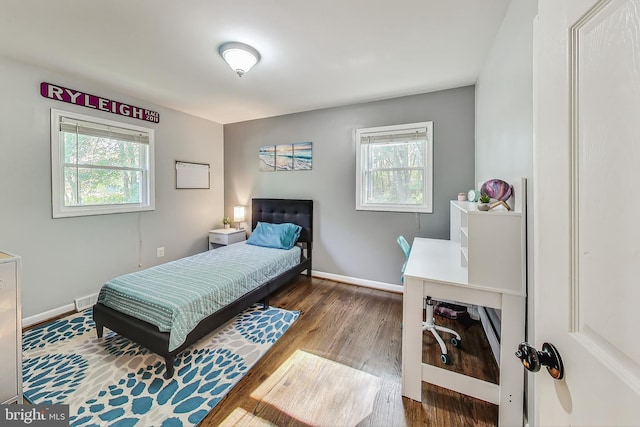 bedroom featuring dark wood-type flooring and multiple windows