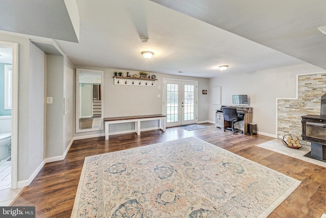 interior space featuring french doors, a wood stove, and wood-type flooring