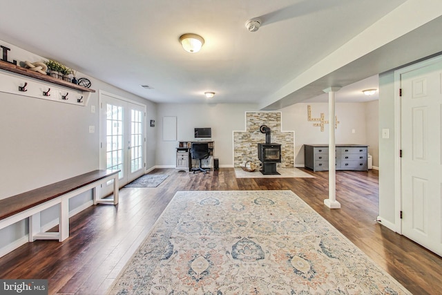 interior space featuring french doors, dark hardwood / wood-style flooring, and a wood stove