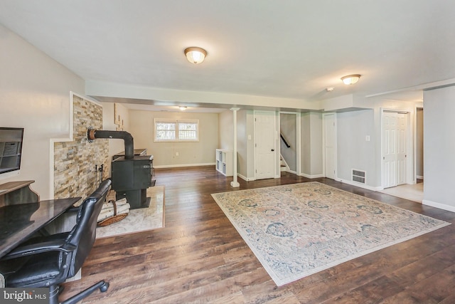 office space with a wood stove and dark hardwood / wood-style floors