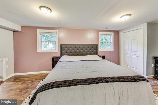 bedroom with a closet and dark hardwood / wood-style floors