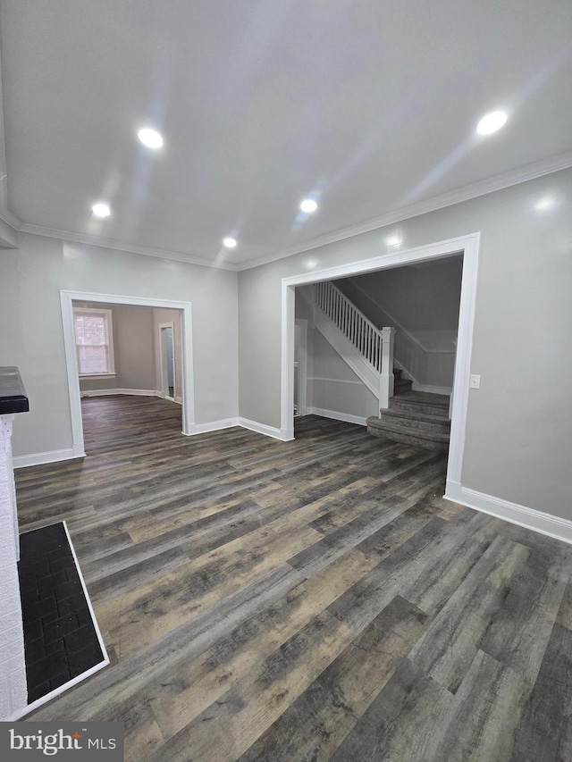 unfurnished living room with dark hardwood / wood-style floors and crown molding