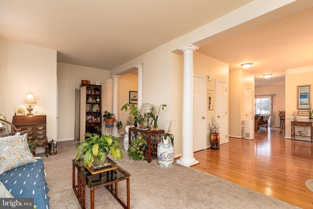 carpeted living room featuring ornate columns