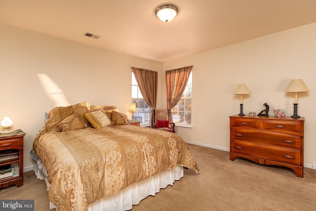 bedroom featuring light carpet