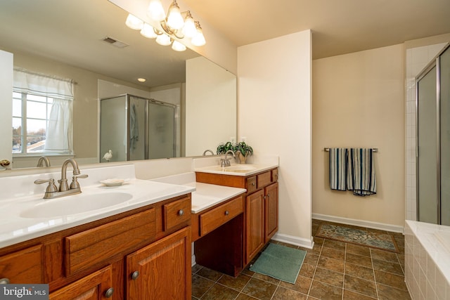 bathroom featuring a shower with door, vanity, and a notable chandelier