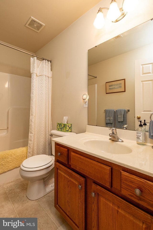 bathroom featuring vanity, toilet, and curtained shower