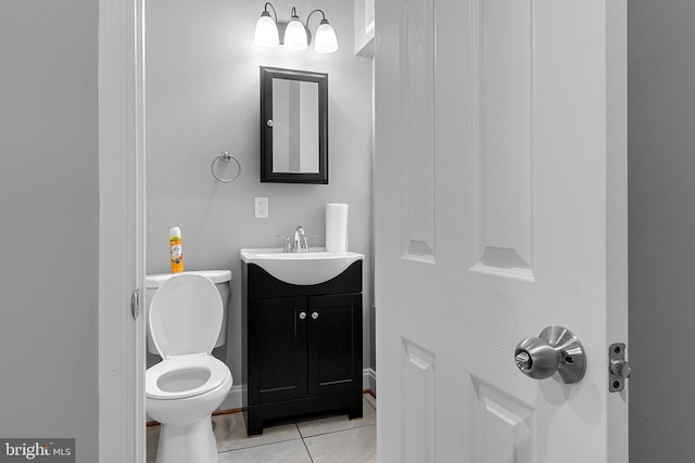 bathroom featuring tile patterned floors, toilet, and vanity