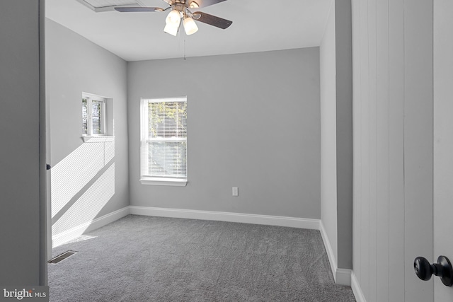 carpeted spare room featuring ceiling fan