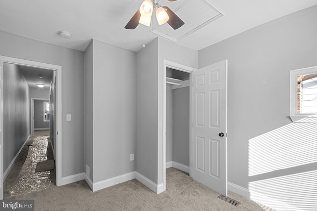 unfurnished bedroom with ceiling fan, a closet, and light carpet