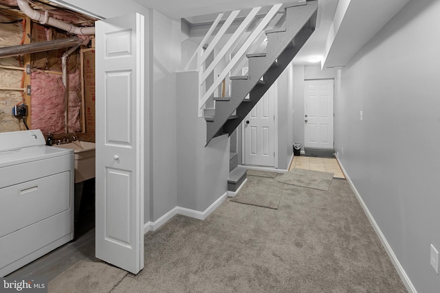 basement with light colored carpet and washer / clothes dryer