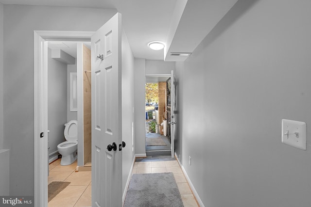 corridor featuring light tile patterned floors