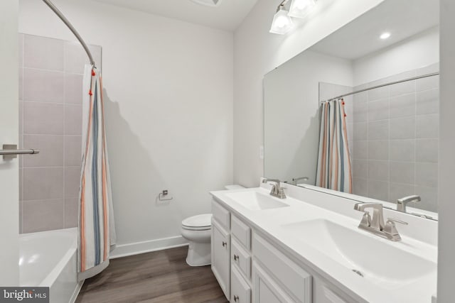 14079 Sunrise Valley Dr Unit 15P, Herndon, VA 20171 - full bathroom featuring wood finished floors, toilet, baseboards, double vanity, and shower / bath combo