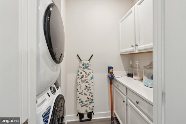 14079 Sunrise Valley Dr Unit 15P, Herndon, VA 20171 - laundry area with cabinet space, stacked washing machine and dryer, and baseboards