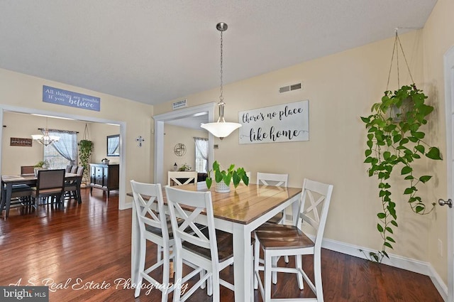 dining space with dark wood-type flooring