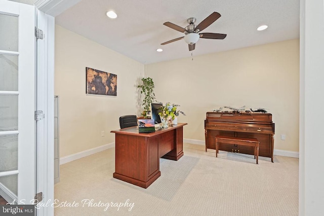 office area with ceiling fan and light carpet