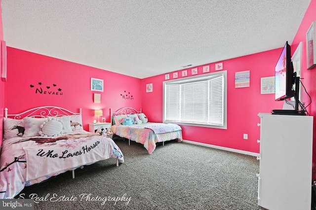 bedroom featuring a textured ceiling and carpet flooring