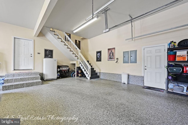 garage with electric panel and a garage door opener