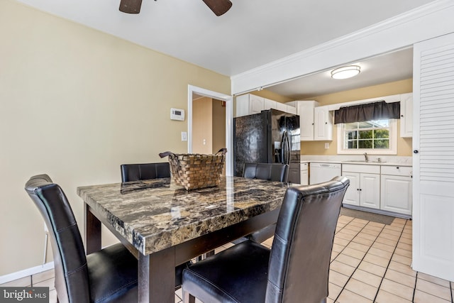 dining area with light tile patterned floors, ceiling fan, and baseboards