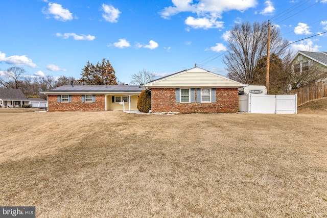 ranch-style home with brick siding, a front yard, and fence