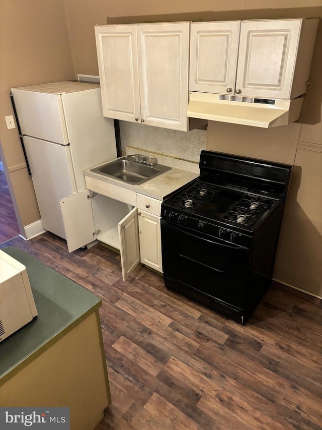 kitchen featuring black gas range, white cabinetry, tasteful backsplash, dark wood-type flooring, and sink