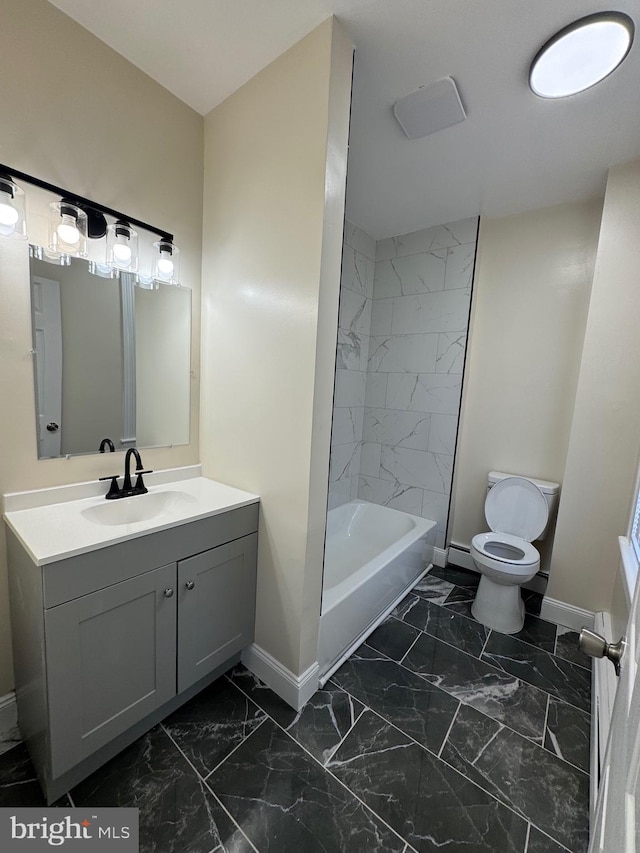 full bathroom featuring toilet, tiled shower / bath combo, and vanity