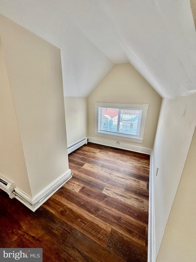 additional living space with vaulted ceiling, baseboard heating, and dark hardwood / wood-style flooring