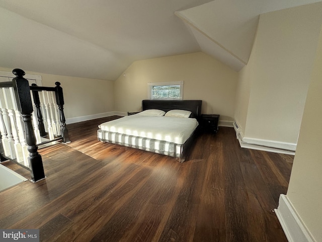 bedroom with dark wood-type flooring, lofted ceiling, and baseboard heating