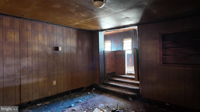 interior space featuring wooden walls