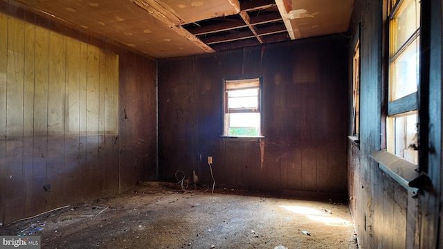 empty room featuring wooden walls