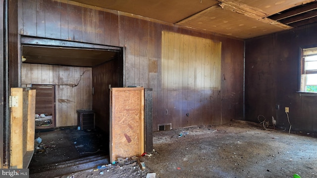 misc room featuring wood walls