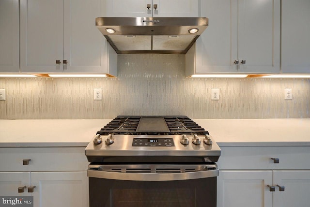 kitchen featuring stainless steel gas stove and white cabinetry