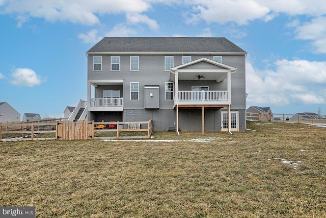 back of house featuring ceiling fan and a lawn