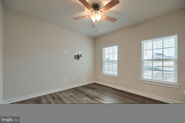 empty room featuring ceiling fan and dark wood-type flooring