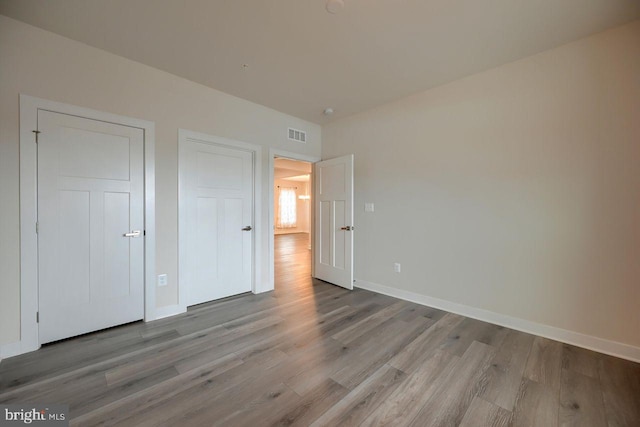 unfurnished bedroom with light hardwood / wood-style floors