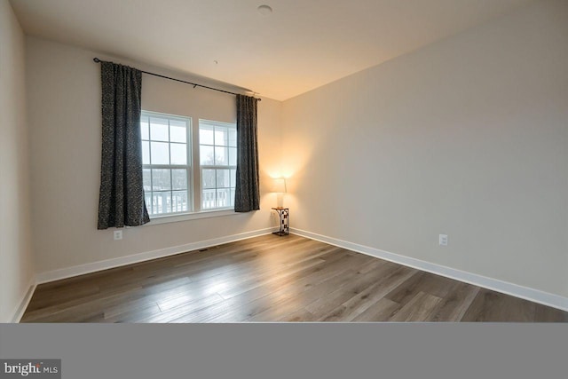 spare room with wood-type flooring