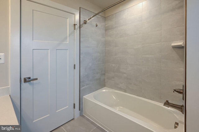 bathroom featuring tiled shower / bath and tile patterned flooring