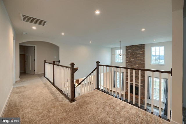 corridor with light colored carpet