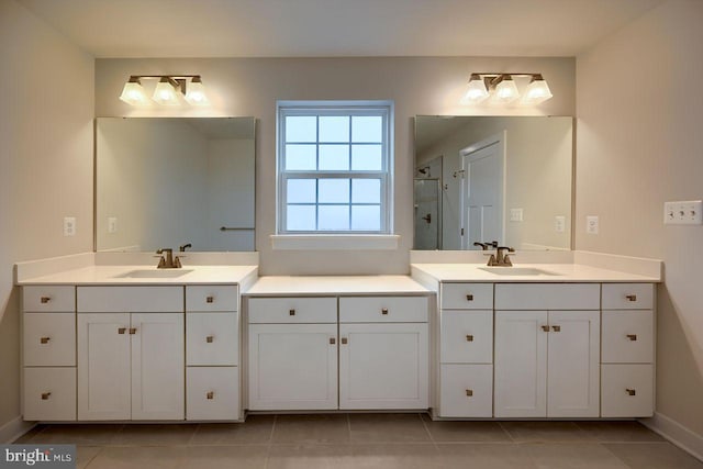 bathroom with tile patterned floors, vanity, and walk in shower