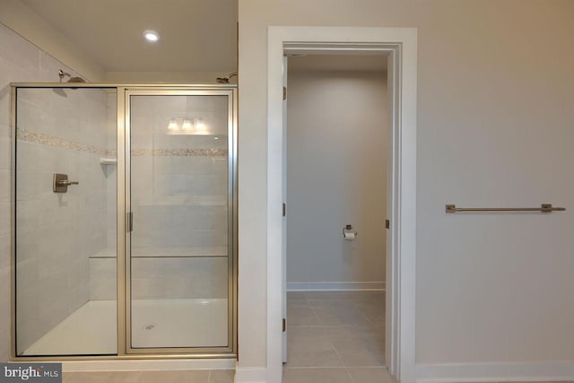 bathroom with tile patterned floors and walk in shower