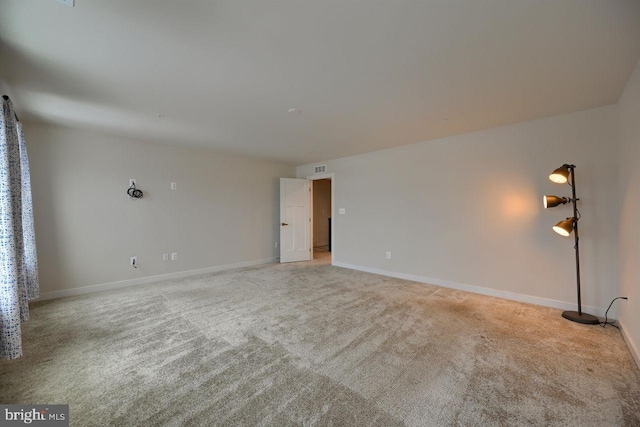 unfurnished room with light carpet