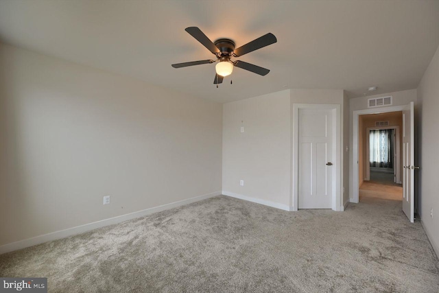 unfurnished bedroom with ceiling fan and light colored carpet