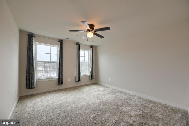 spare room featuring ceiling fan and carpet flooring