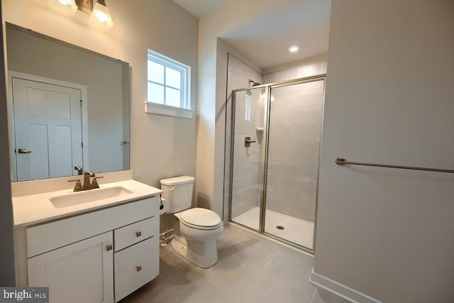 bathroom featuring toilet, vanity, tile patterned flooring, and a shower with door