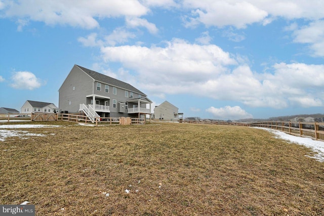 rear view of property with a yard