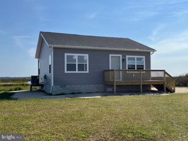 rear view of house featuring a yard and a deck