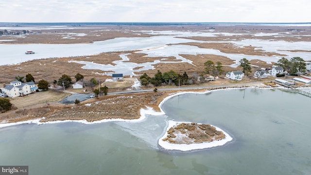 snowy aerial view featuring a water view