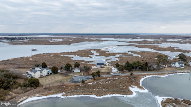 snowy aerial view featuring a water view